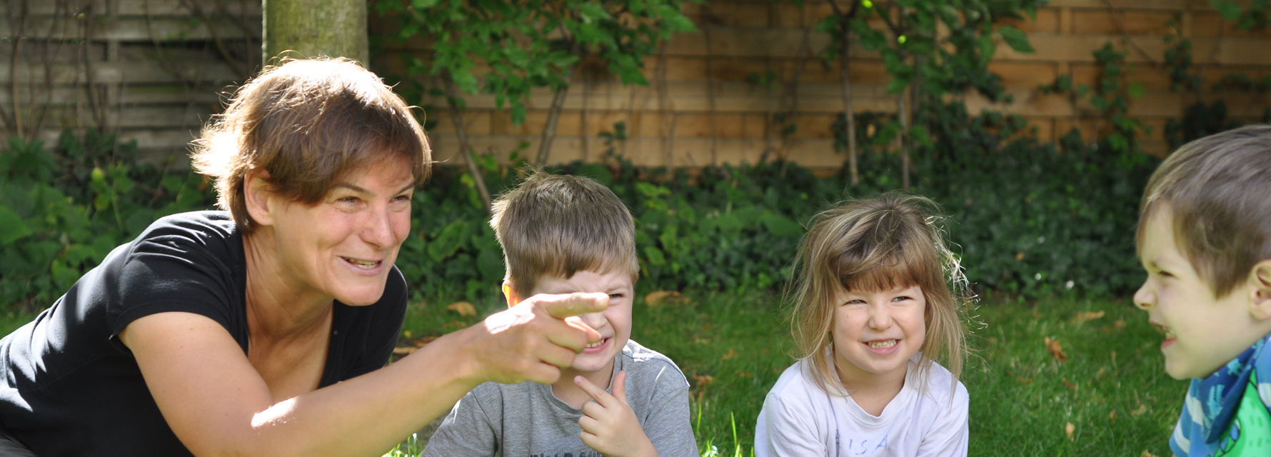 LesArt-Mitarbeiterin mit Kindern im Garten